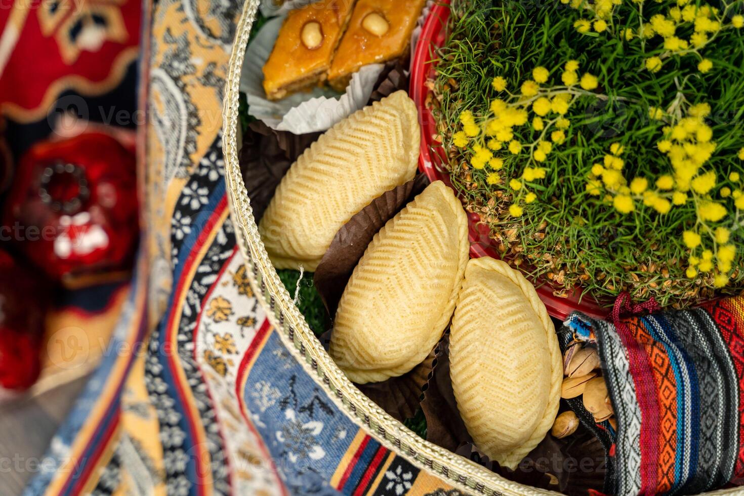 Novruz plate with Azerbaijan national pastry shekerbura and green semeni wheat grass photo