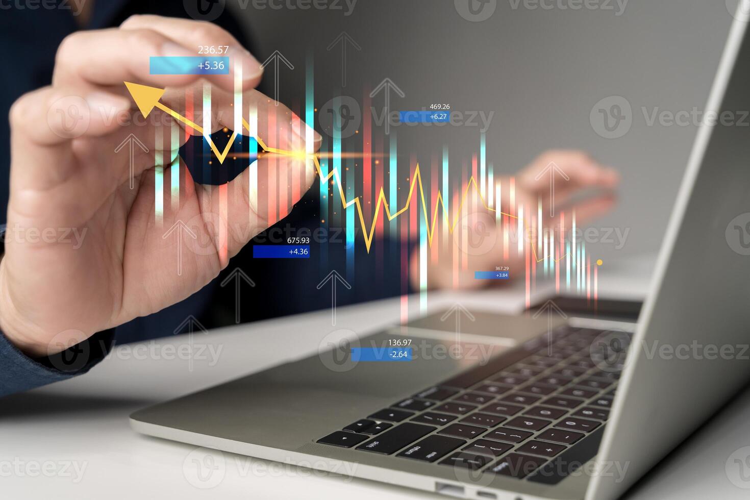 Hand analyzing stock market graph and financial candlestick chart with futuristic data on laptop screen photo