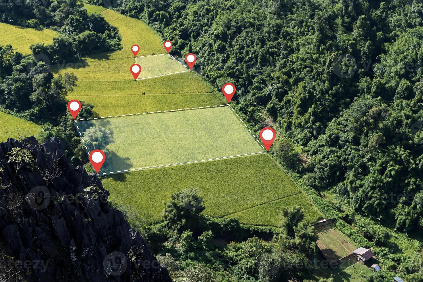 Aerial view of rice fields with location pins and boundary lines in tropical mountain valley farmland area photo