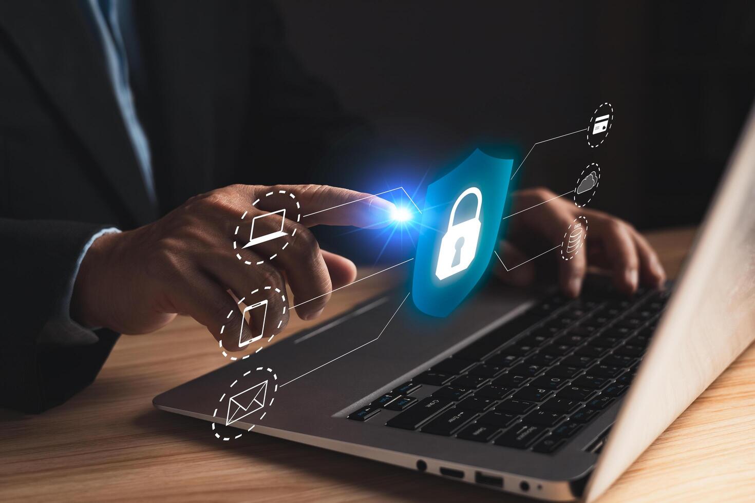A hand touches a glowing lock icon on a laptop, symbolizing cyber security, data protection, and secure access to networks, highlighting the importance of digital safety and privacy. photo