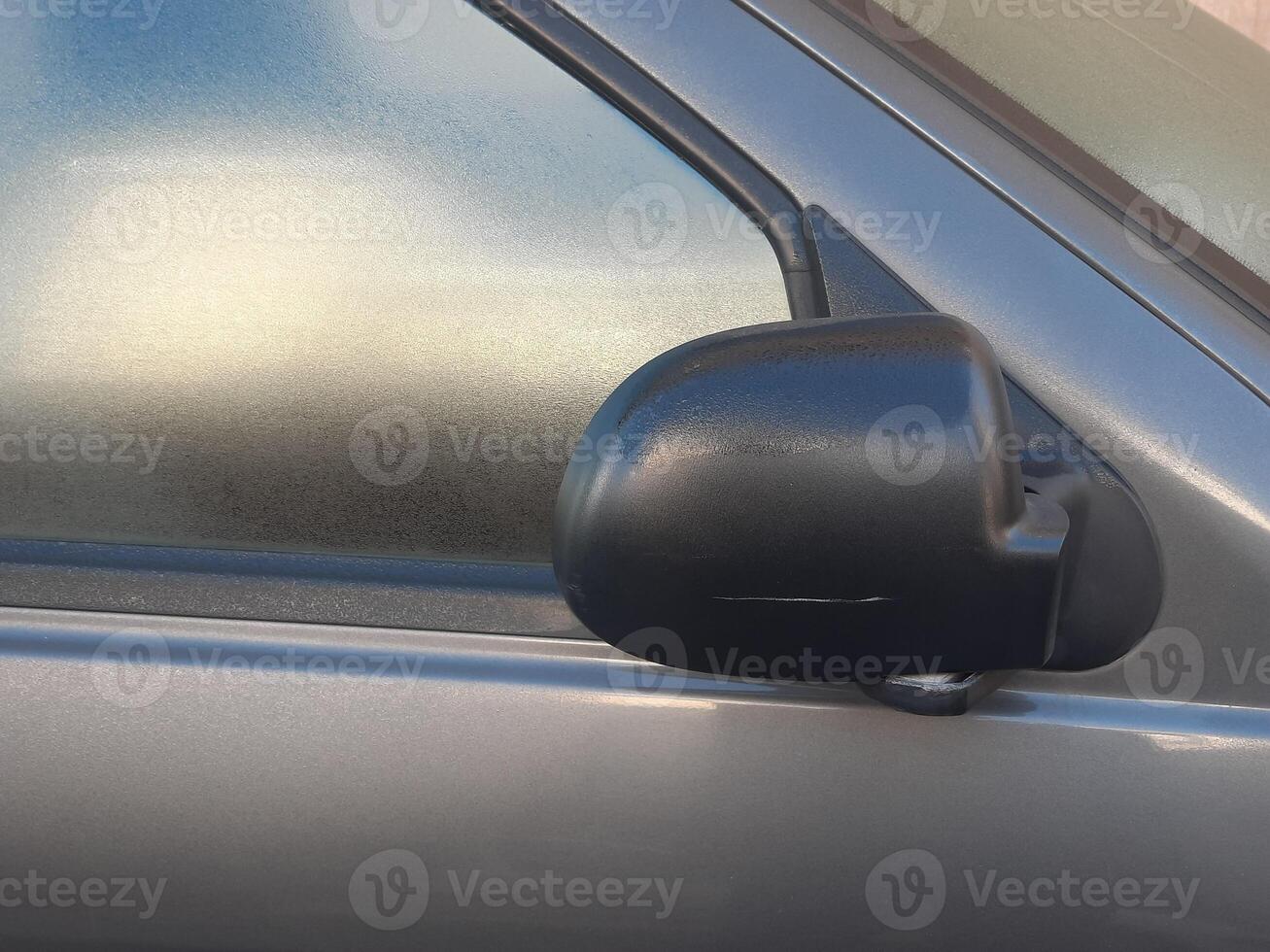 Side rear-view mirror closed for safety - close up shot photo
