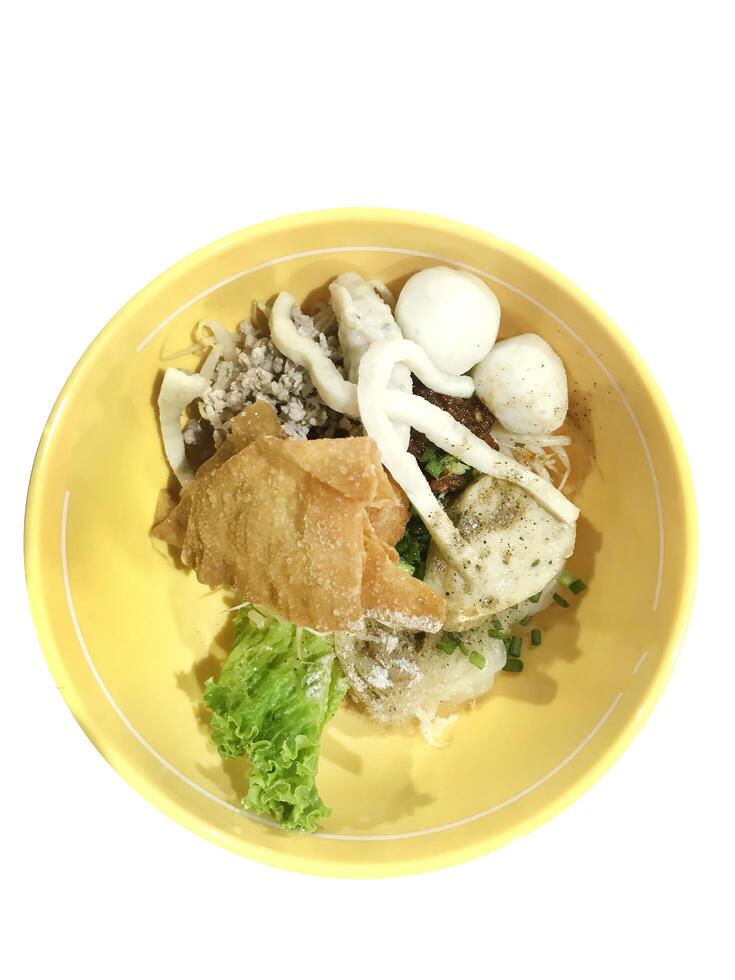 Top view of Spicy TOM YAM fish ball noodle with lemongrass, chilly pasted and lime juice, focus selective photo