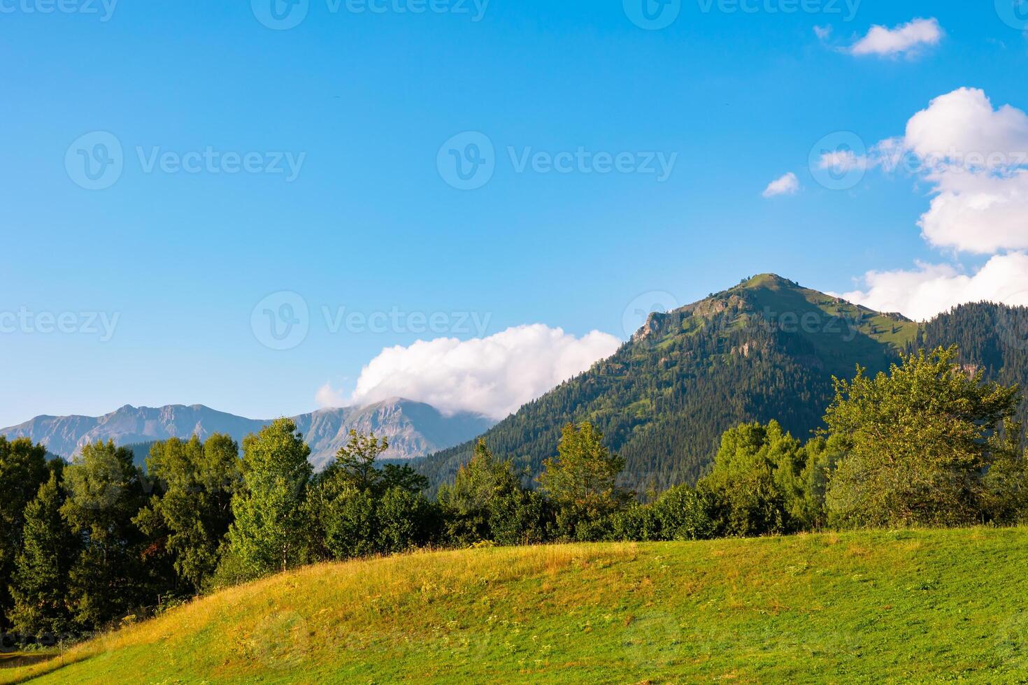 Landscape of the rural area. Rolling clouds over the mountains photo