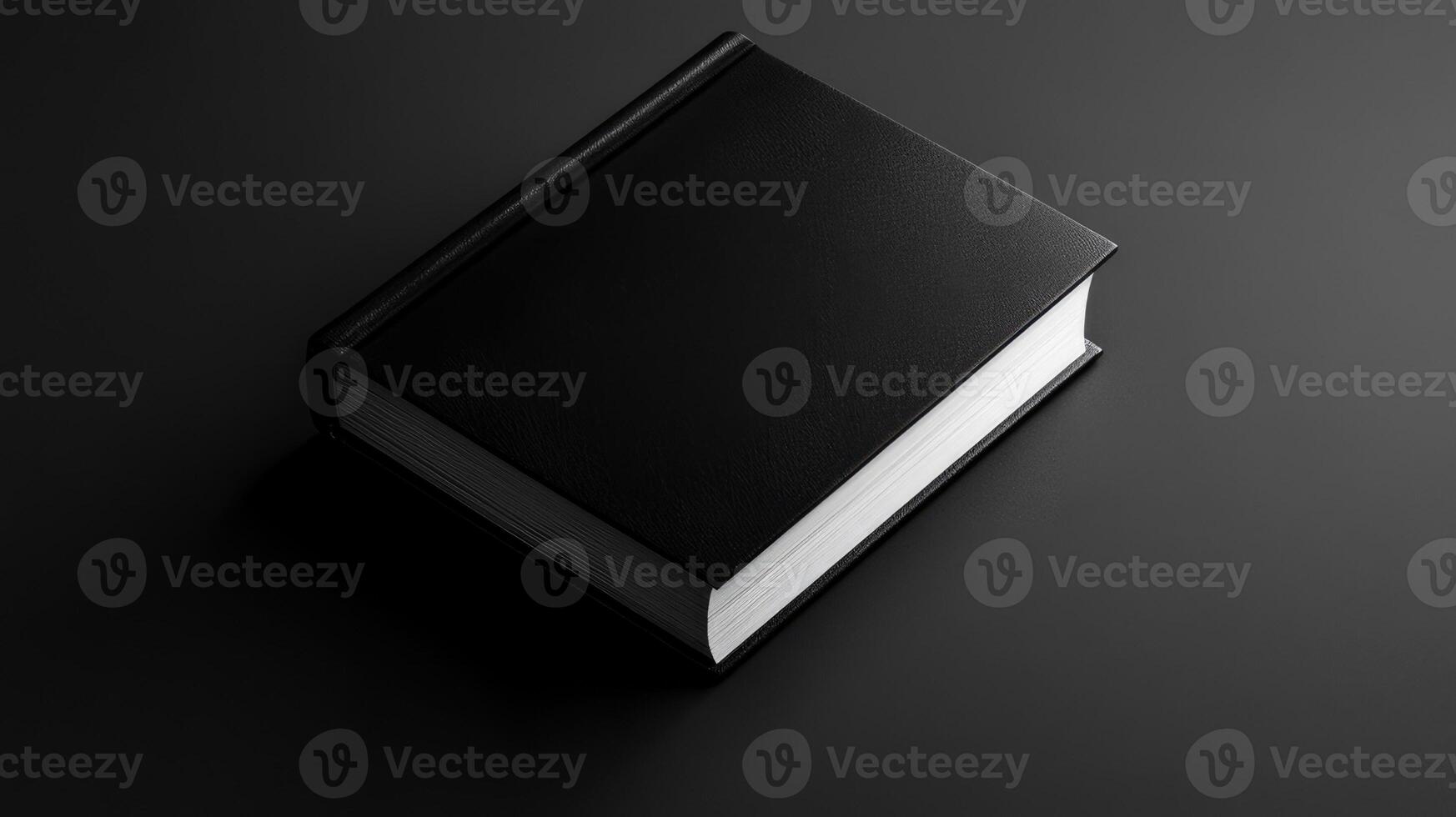An elegant black book lying on a monochrome surface and displaying a minimalist design. Mockup photo