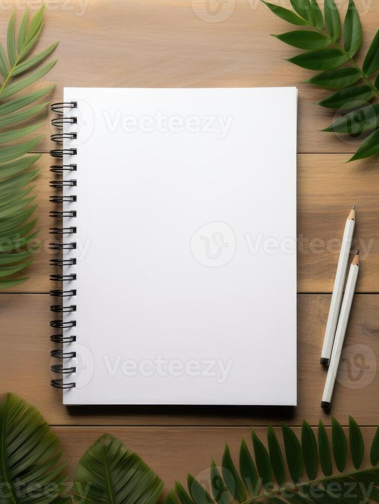 A blank notebook surrounded by nature awakens creativity in a serene workspace. photo