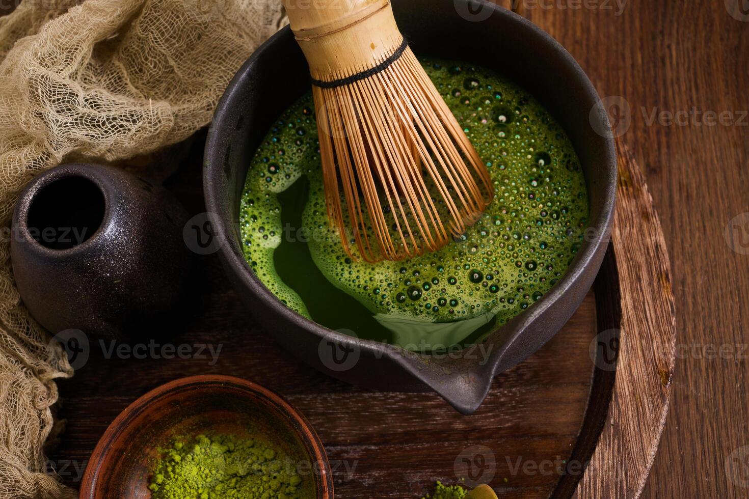 Traditional Matcha Preparation. Elegant matcha tea setup with whisk photo