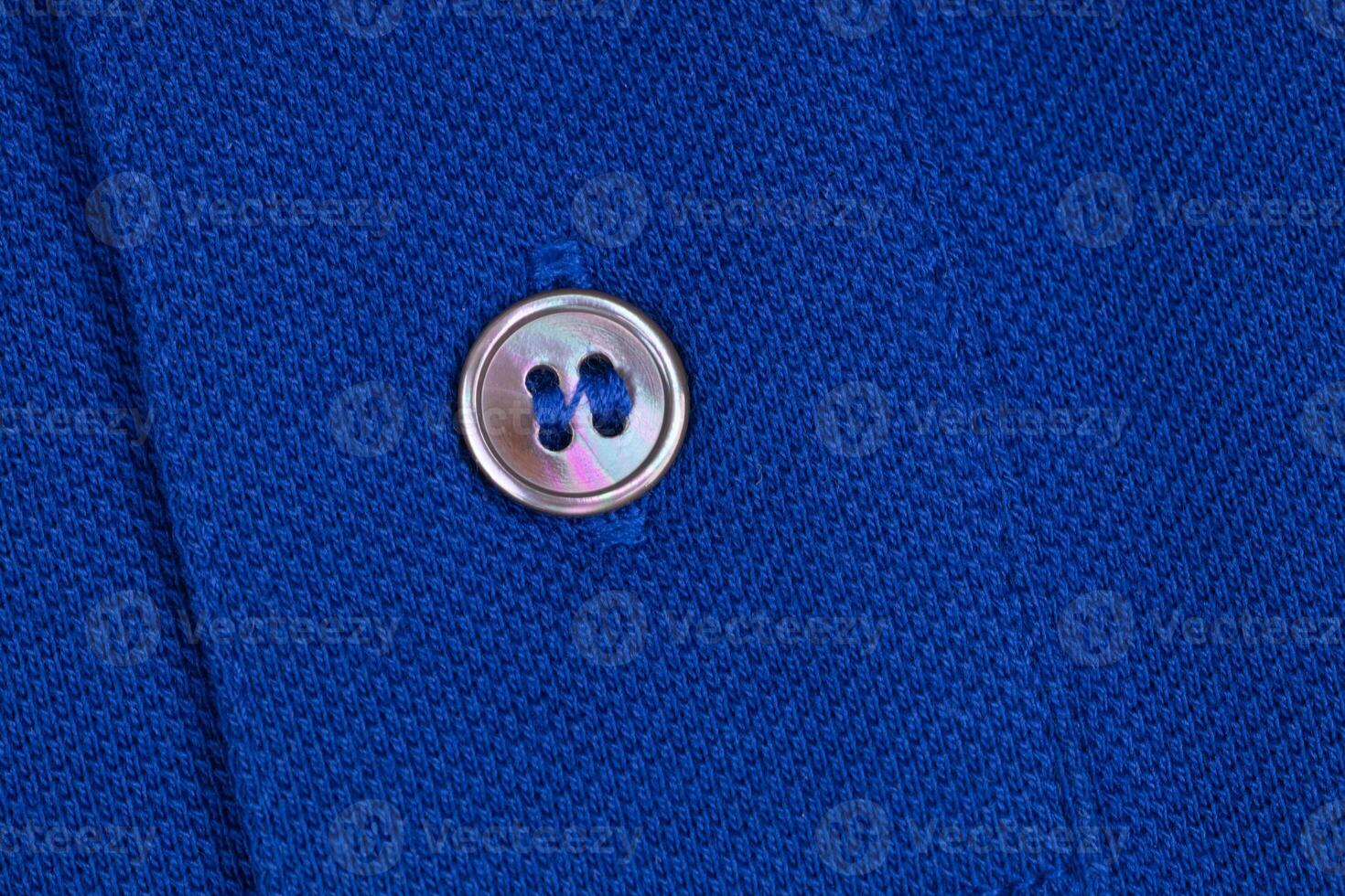 Shiny Pearl Button On Blue Knit Fabric photo