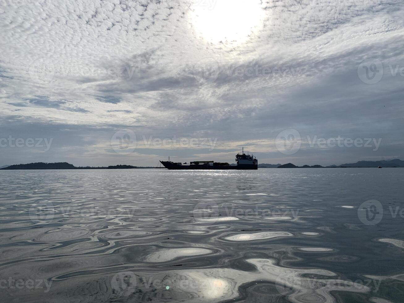 a large ship in the water with a sunset background photo