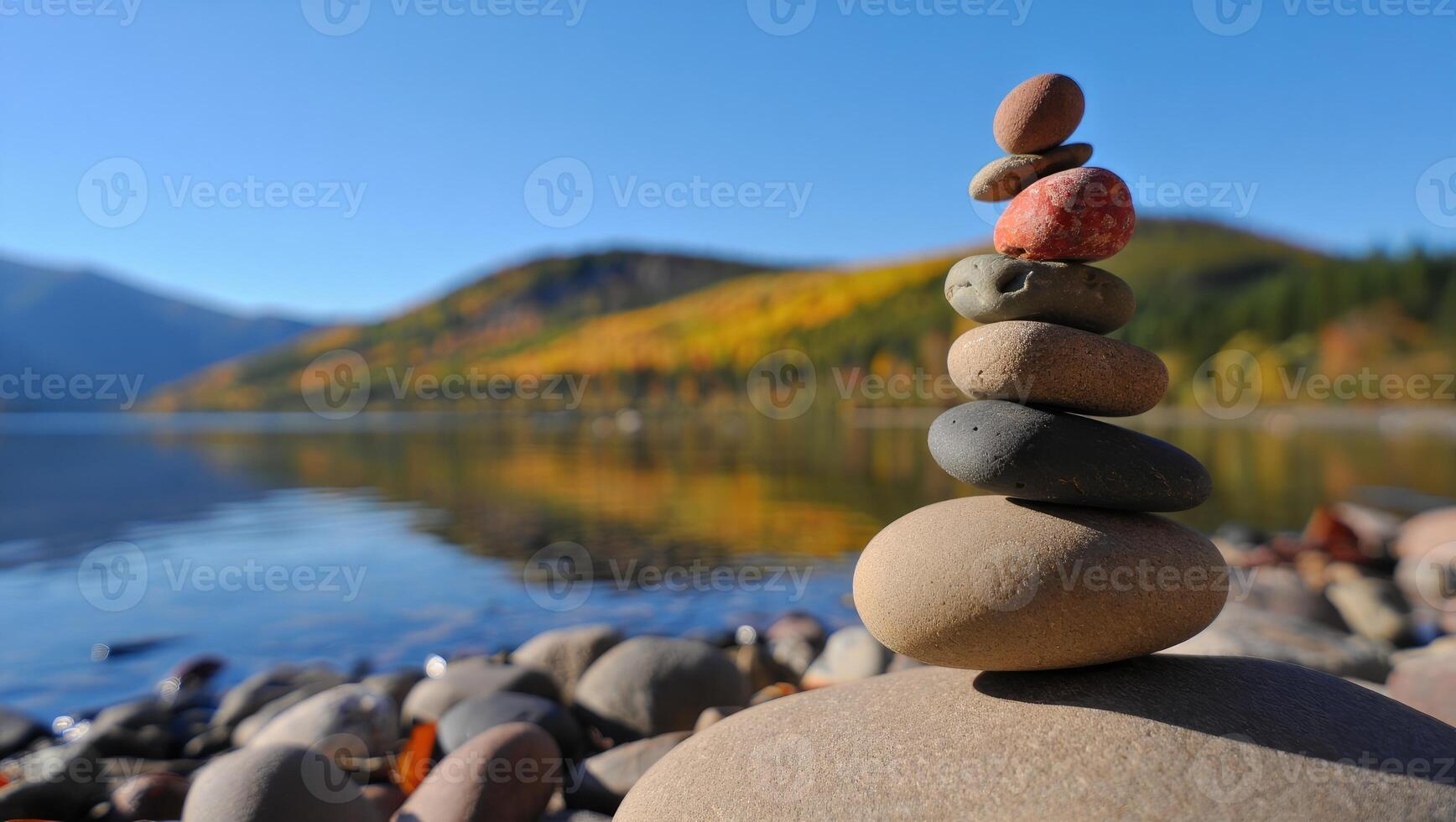 Stone stacking on Montana lake shore during beautiful autumn day photo