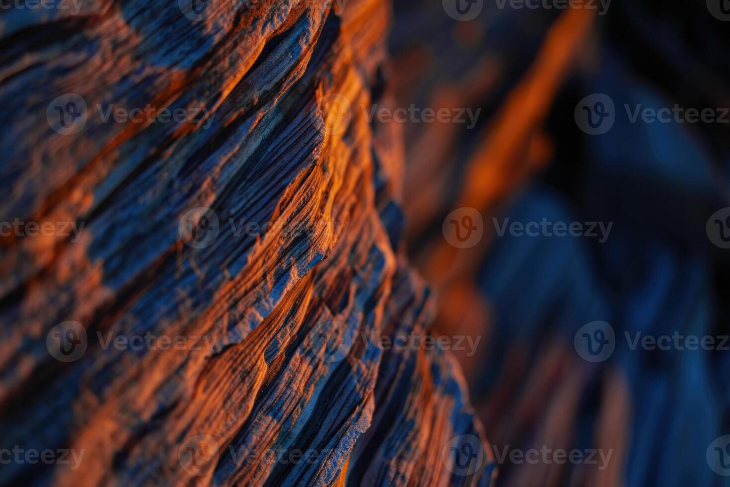 Intriguing close up of a textured rock formation, displaying an interplay of light and shadow. photo