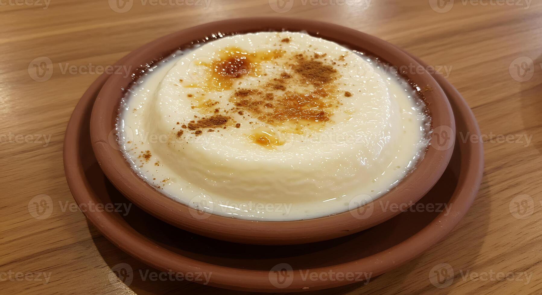 A bowl of pudding with cinnamon on top photo