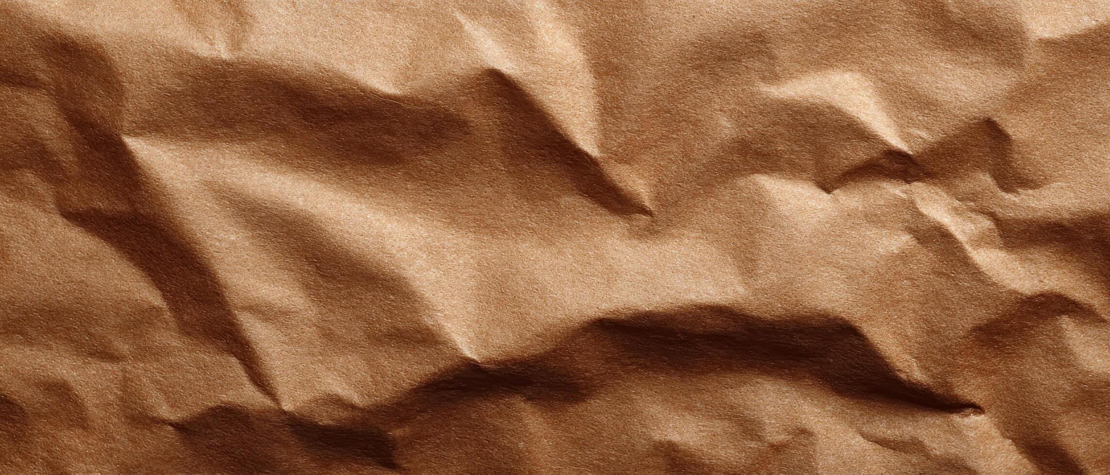 Closeup of crumpled brown paper texture natural light abstract design studio setting photo