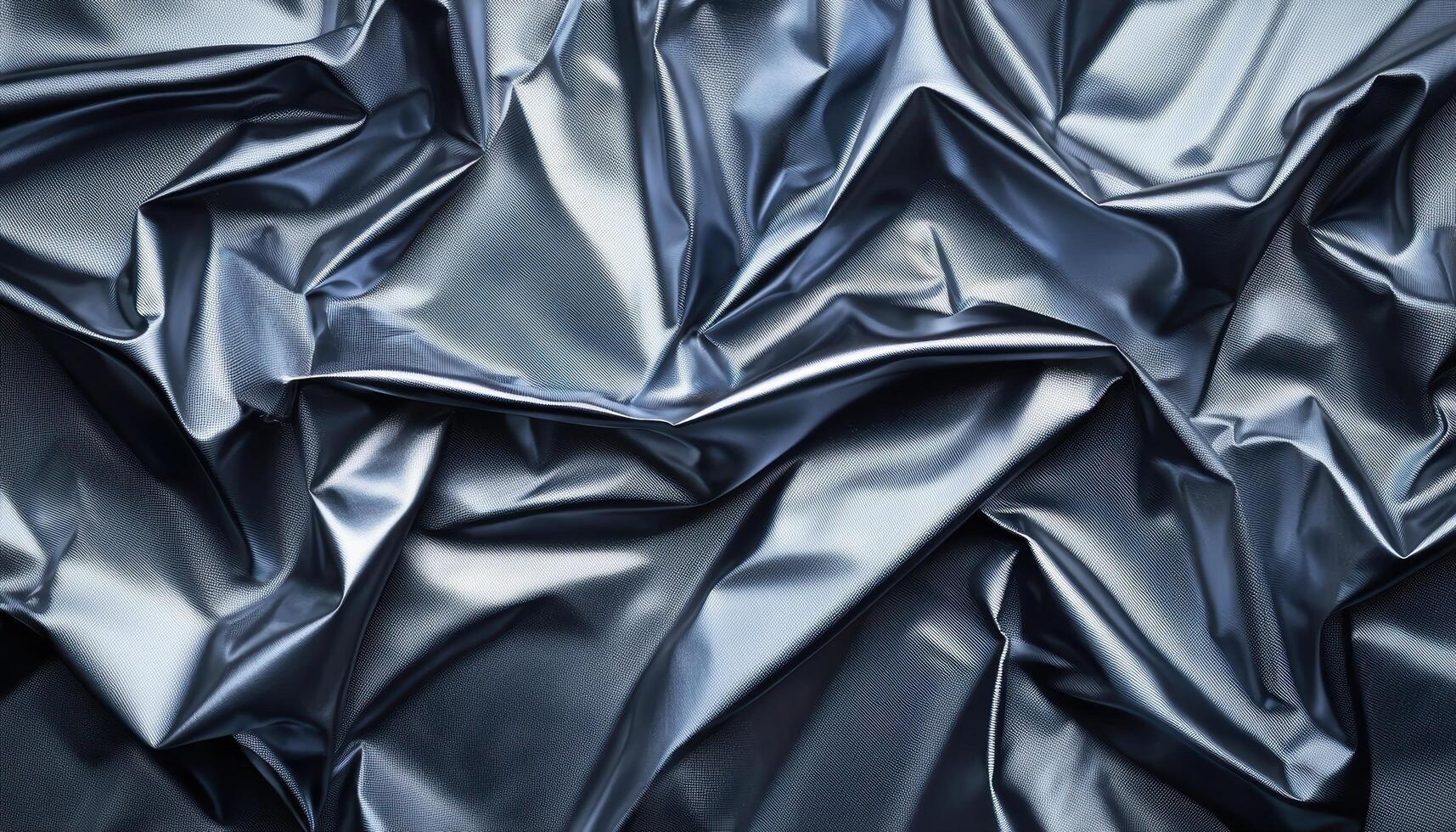 Illuminated abstract shapes of crumpled metallic foil in high fidelity close-up artistic view photo