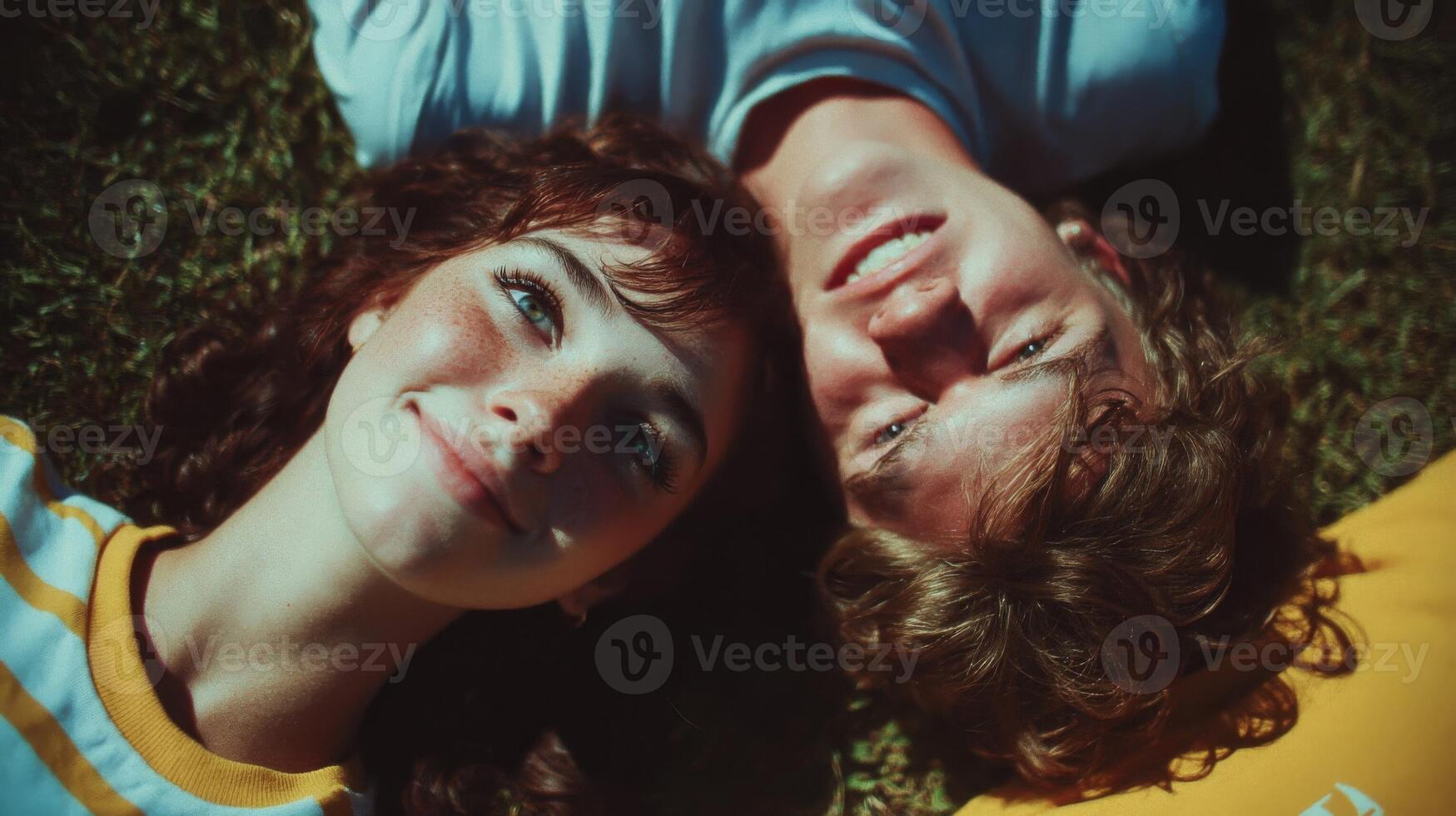 Young Couple Lying on Grass, Happy and Romantic Portrait photo