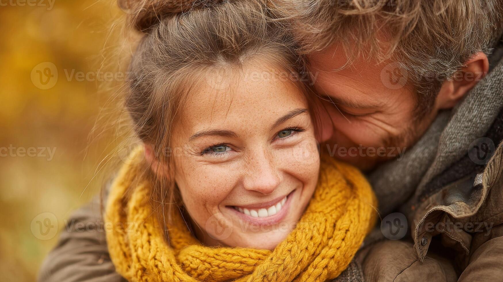 Happy Couple Embracing in Autumn Snow photo