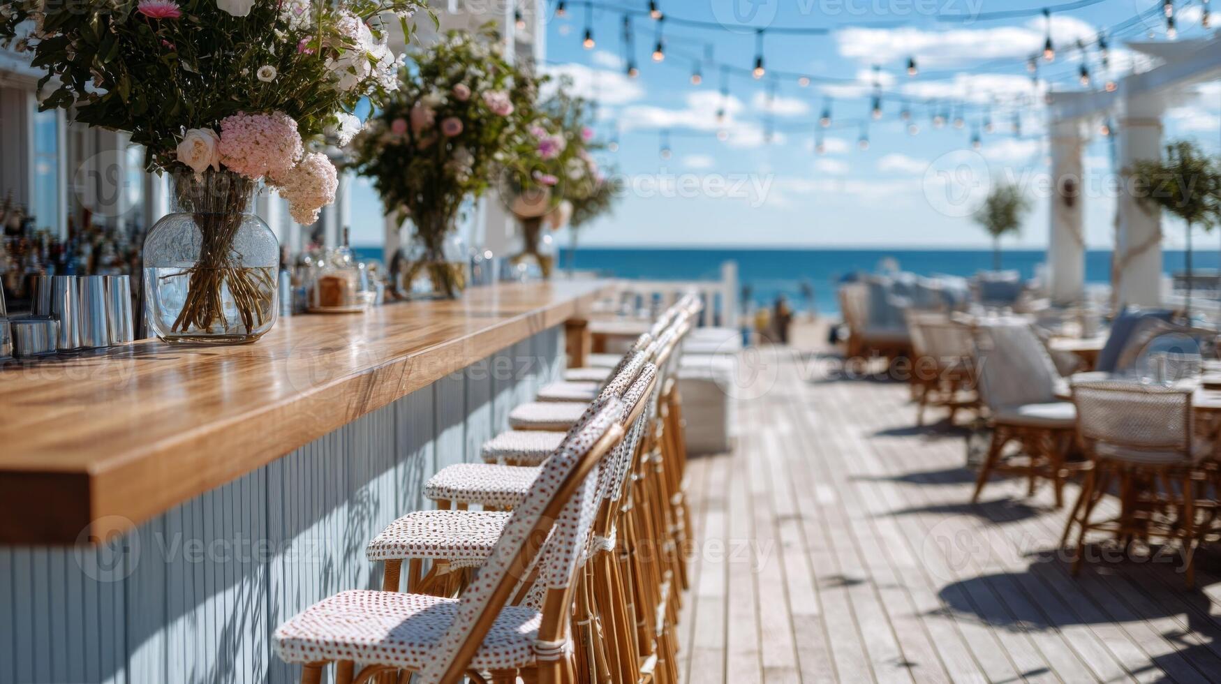 Beachfront Bar with Ocean View and Floral Decor photo