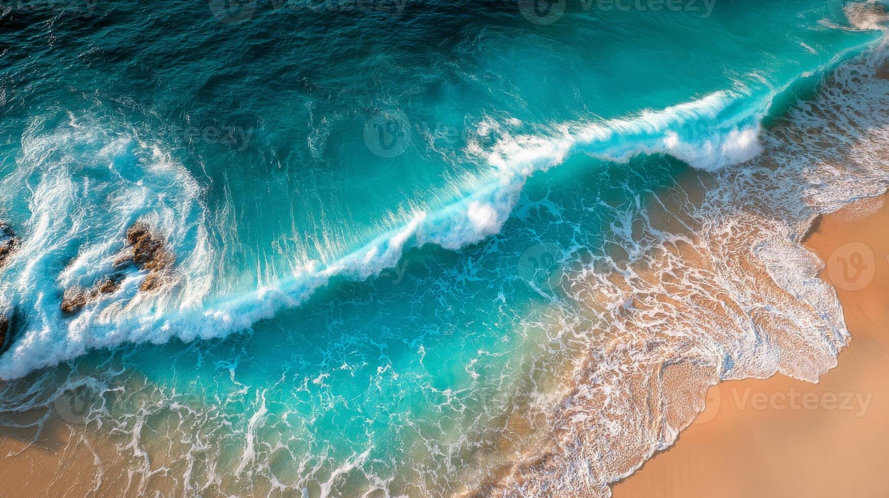 Top View of Turquoise Ocean Waves Crashing on Sandy Beach photo