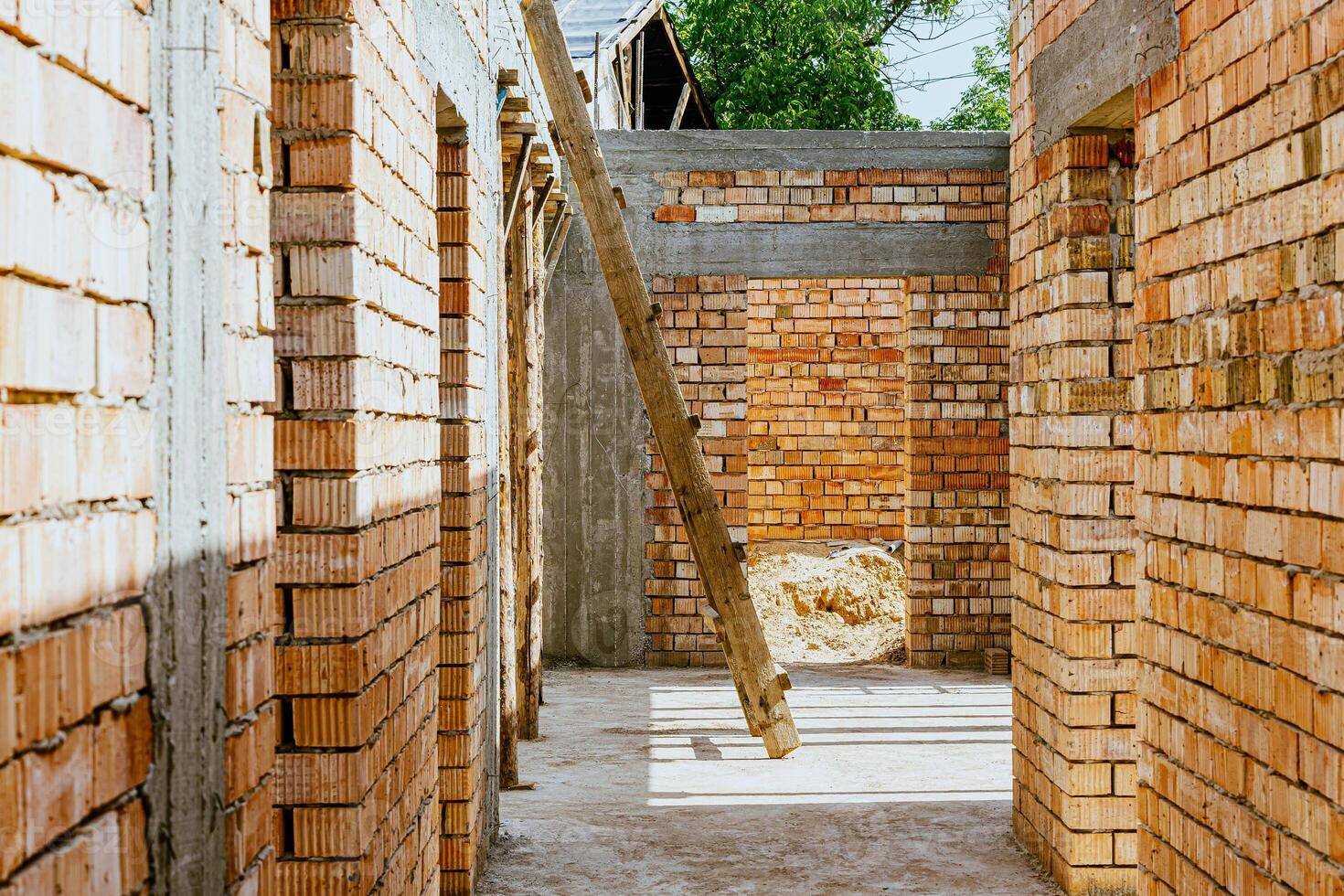 A brick wall with a ladder and a window photo