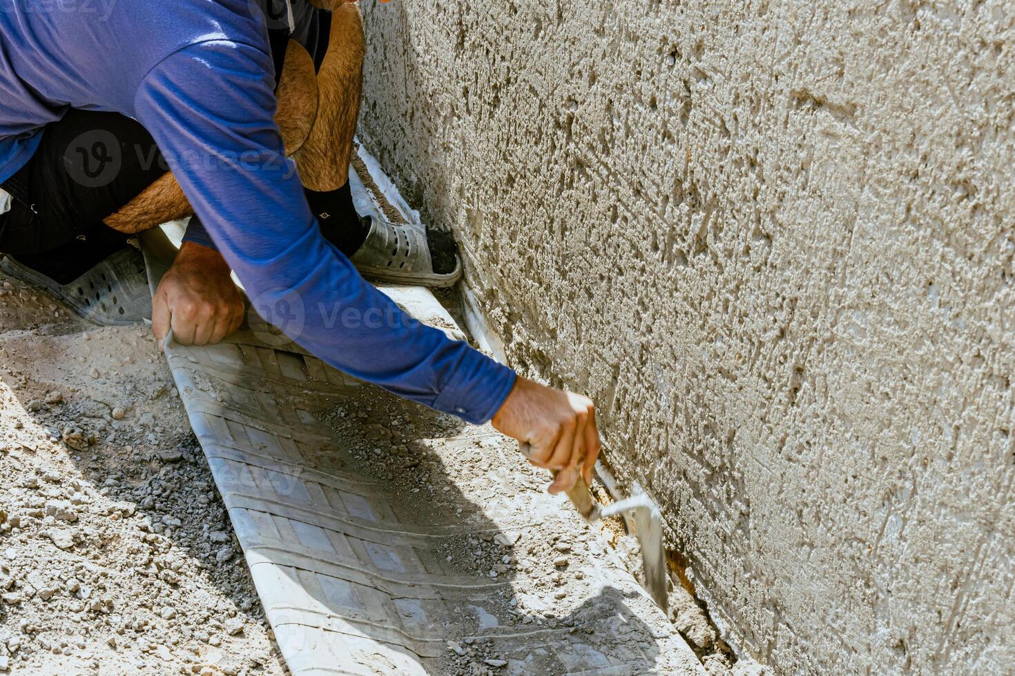 A man is working on a wall with a cement board photo