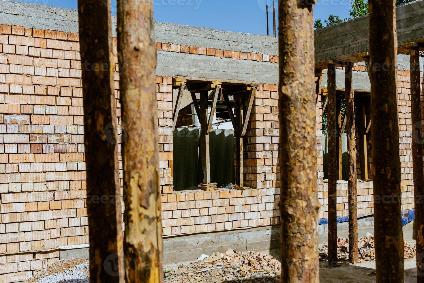 A building under construction with a large wooden beam photo