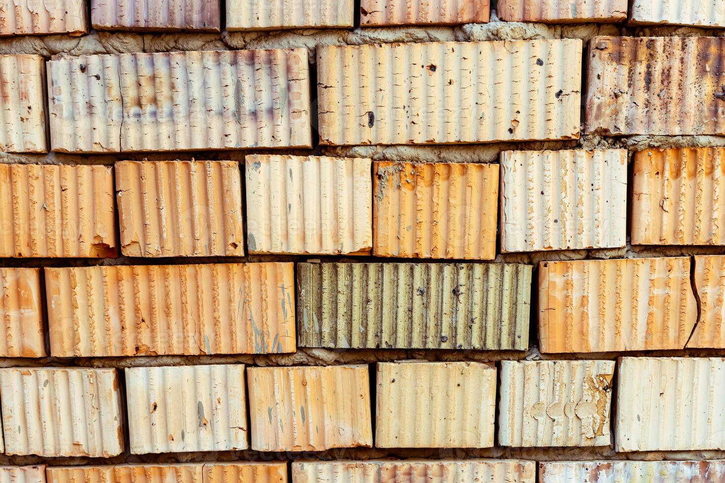 A wall made of bricks with a few different colors photo