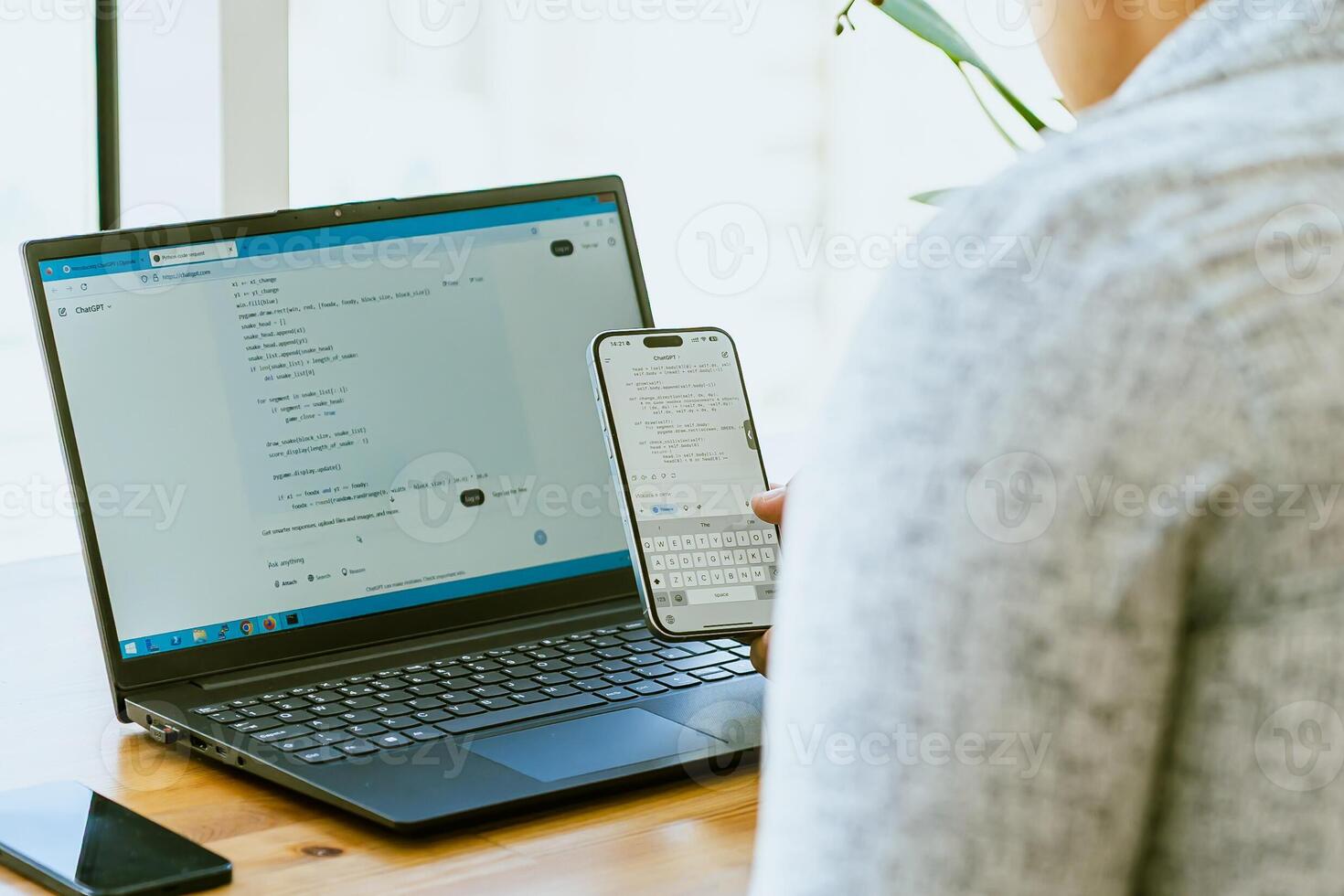 A woman using a laptop to access a website photo