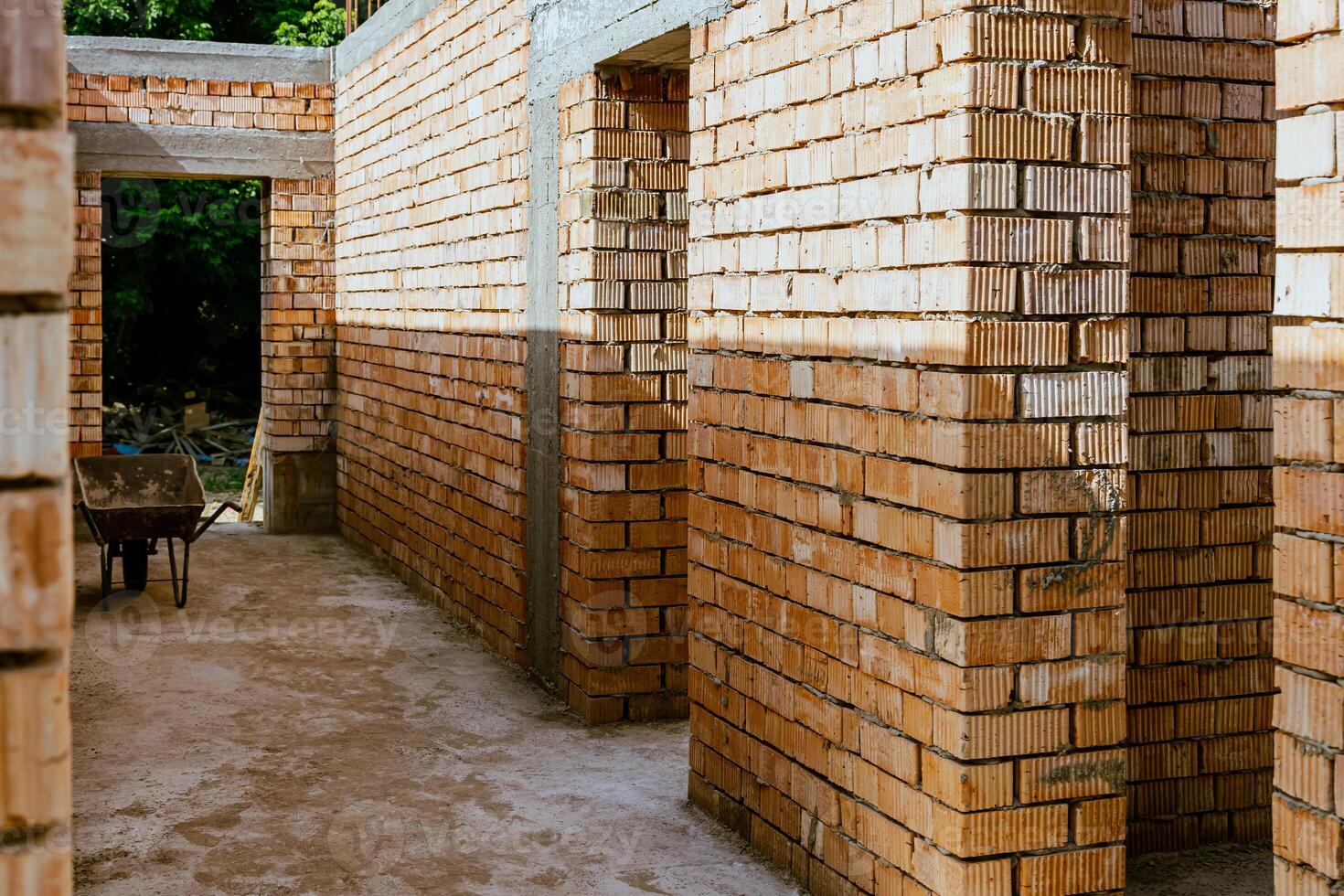 A brick wall with a bench in the middle photo