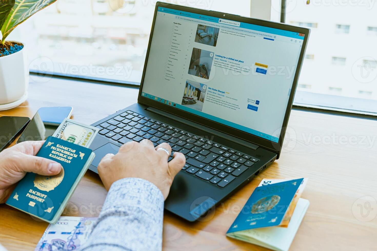 Man using laptop and passport in office photo