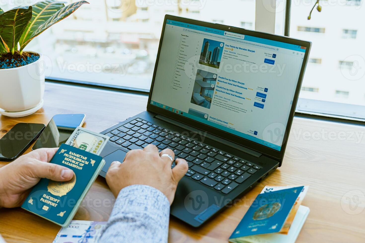 A man using a laptop to search for flights photo