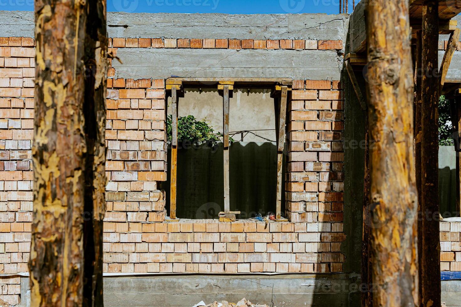 A man standing in front of a building with a ladder photo