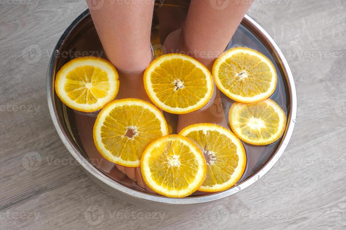 Foot bath with orange slices photo
