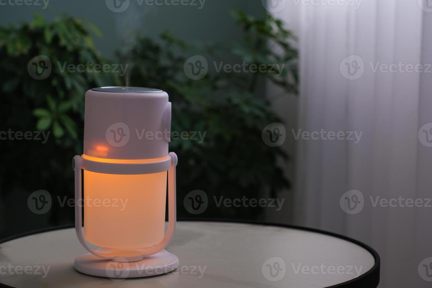 An illuminated humidifier on the table in the room photo