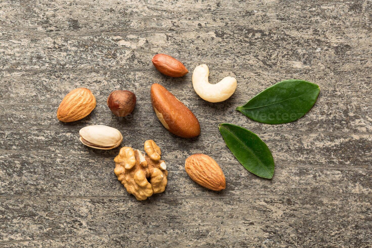 Composition of nuts , mix hazelnuts, cashews, almonds on table background. healthy eating concepts and food background photo
