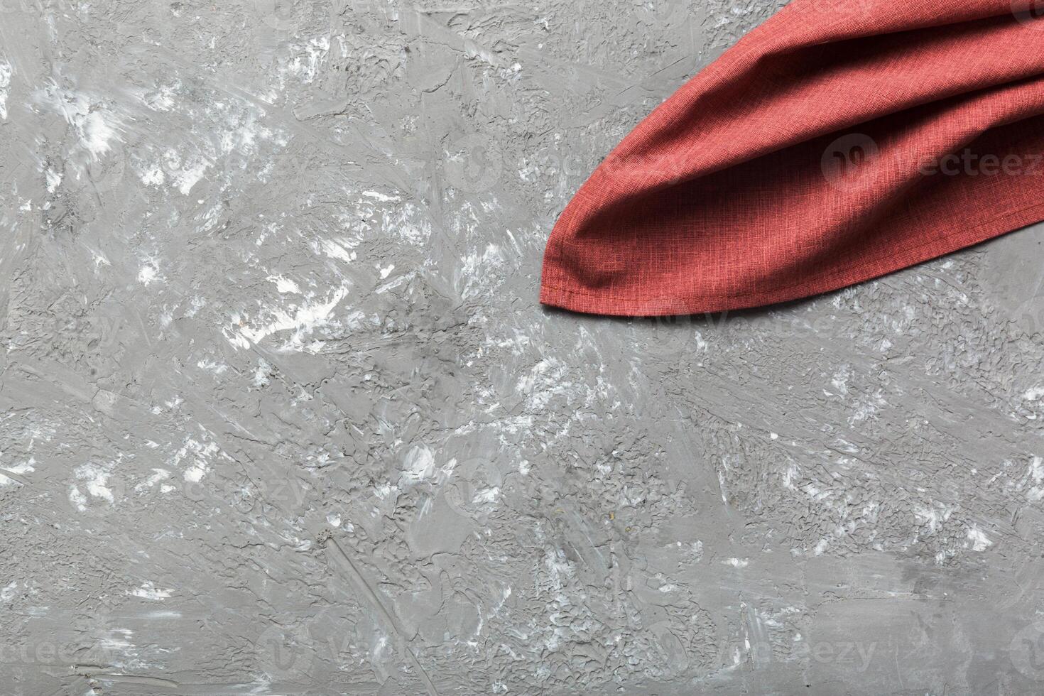 top view red empty kitchen napkin isolated on table. Folded cloth for mockup photo