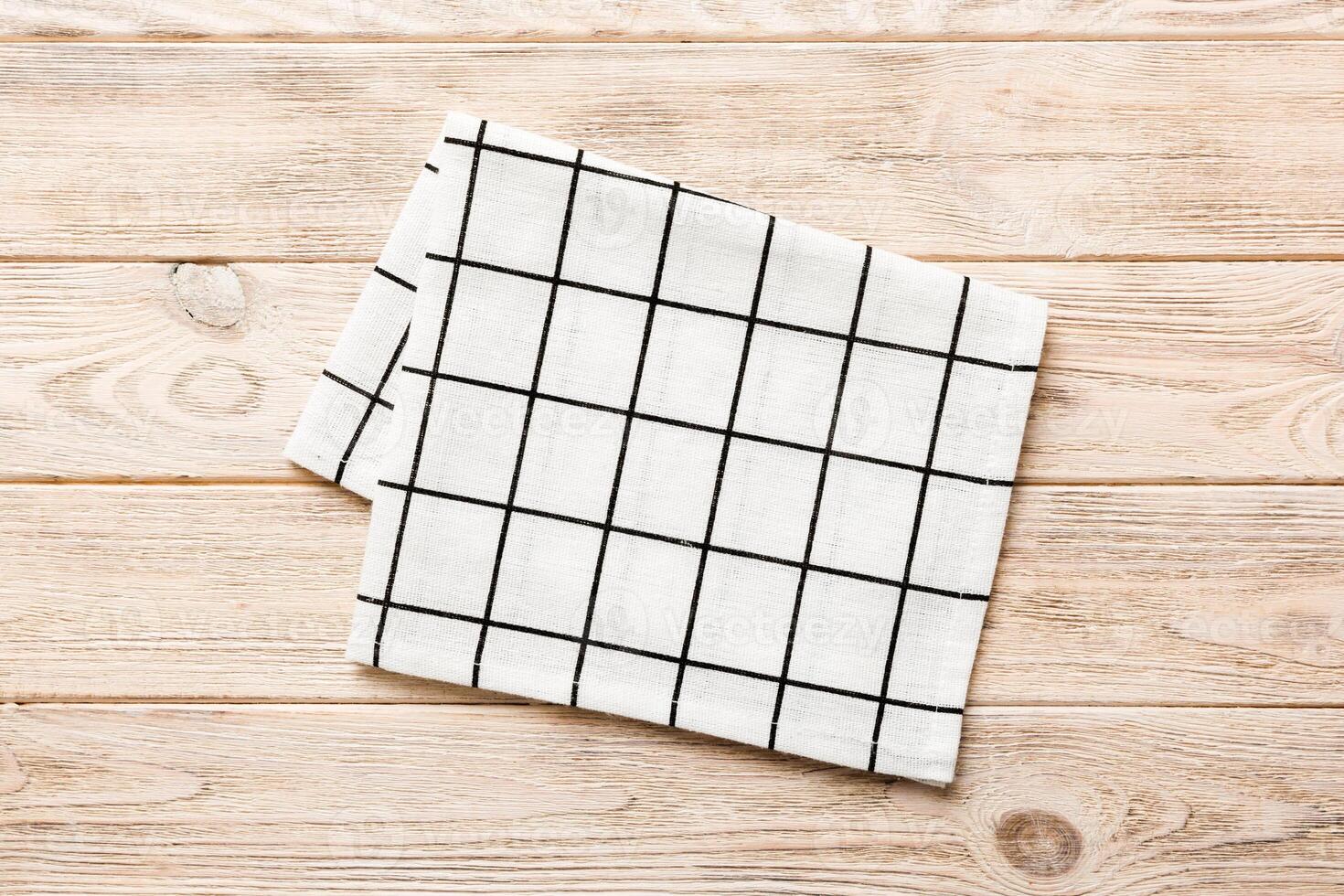 top view with white empty kitchen napkin isolated on table . Folded cloth for mockup photo