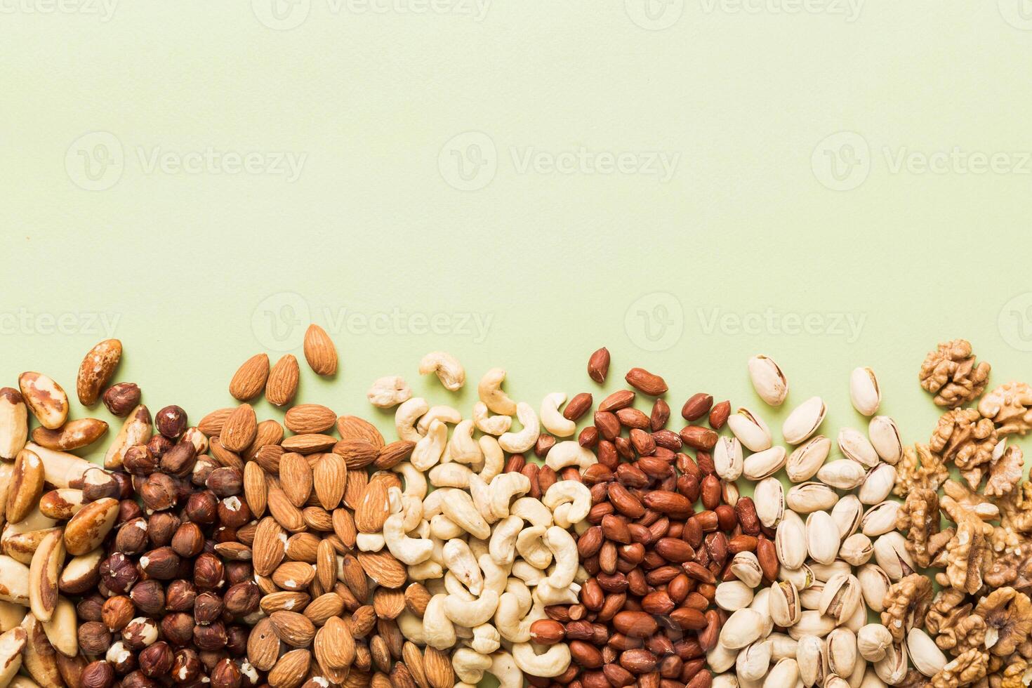 different nuts frame background. flat lay with vopy space. Walnut, almonds, hazelnuts photo