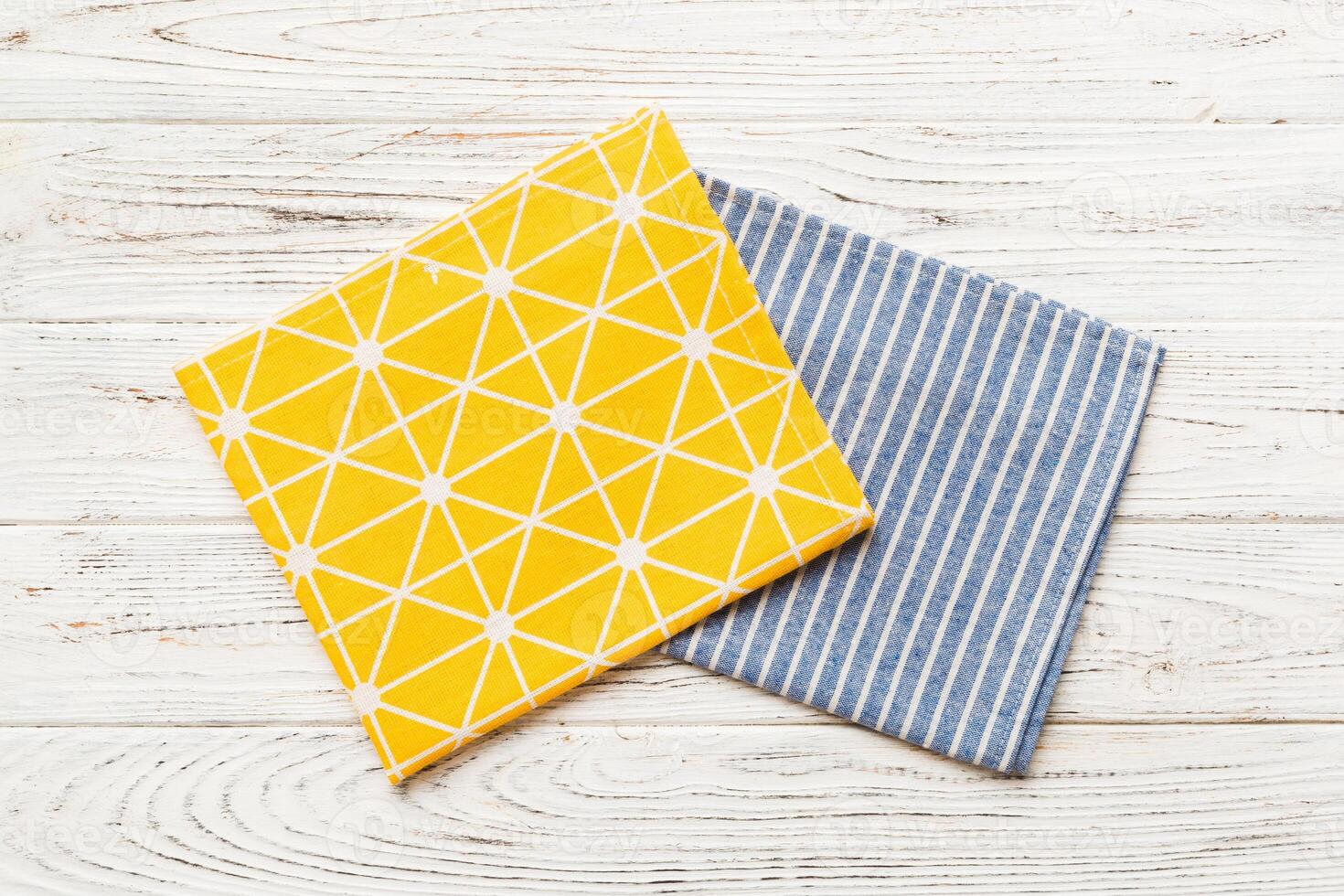 top view yellow empty kitchen napkin isolated on table background. Folded cloth for mockup , Minimal style photo