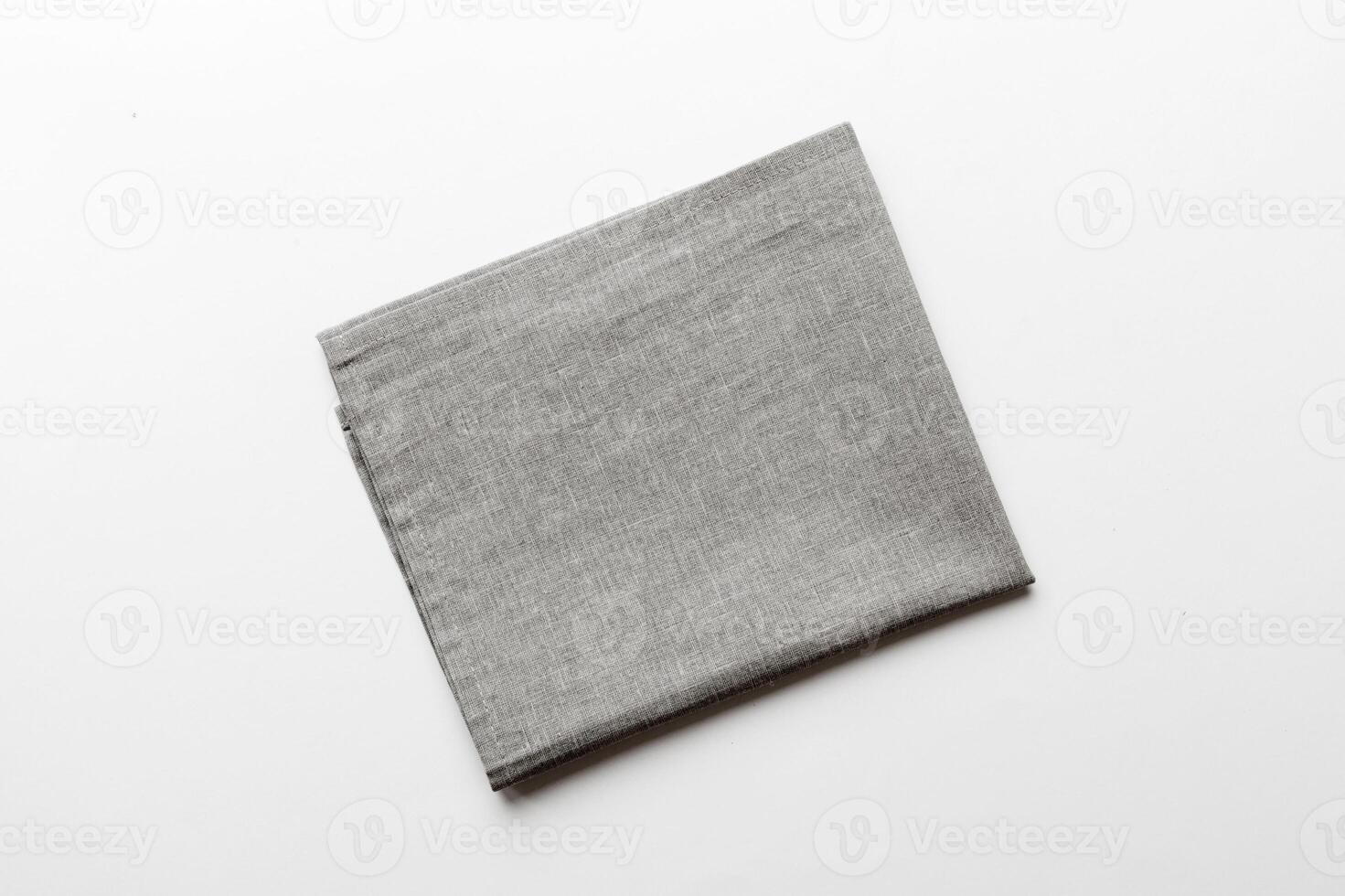 top view with gray kitchen napkin isolated on table. Folded cloth for mockup photo