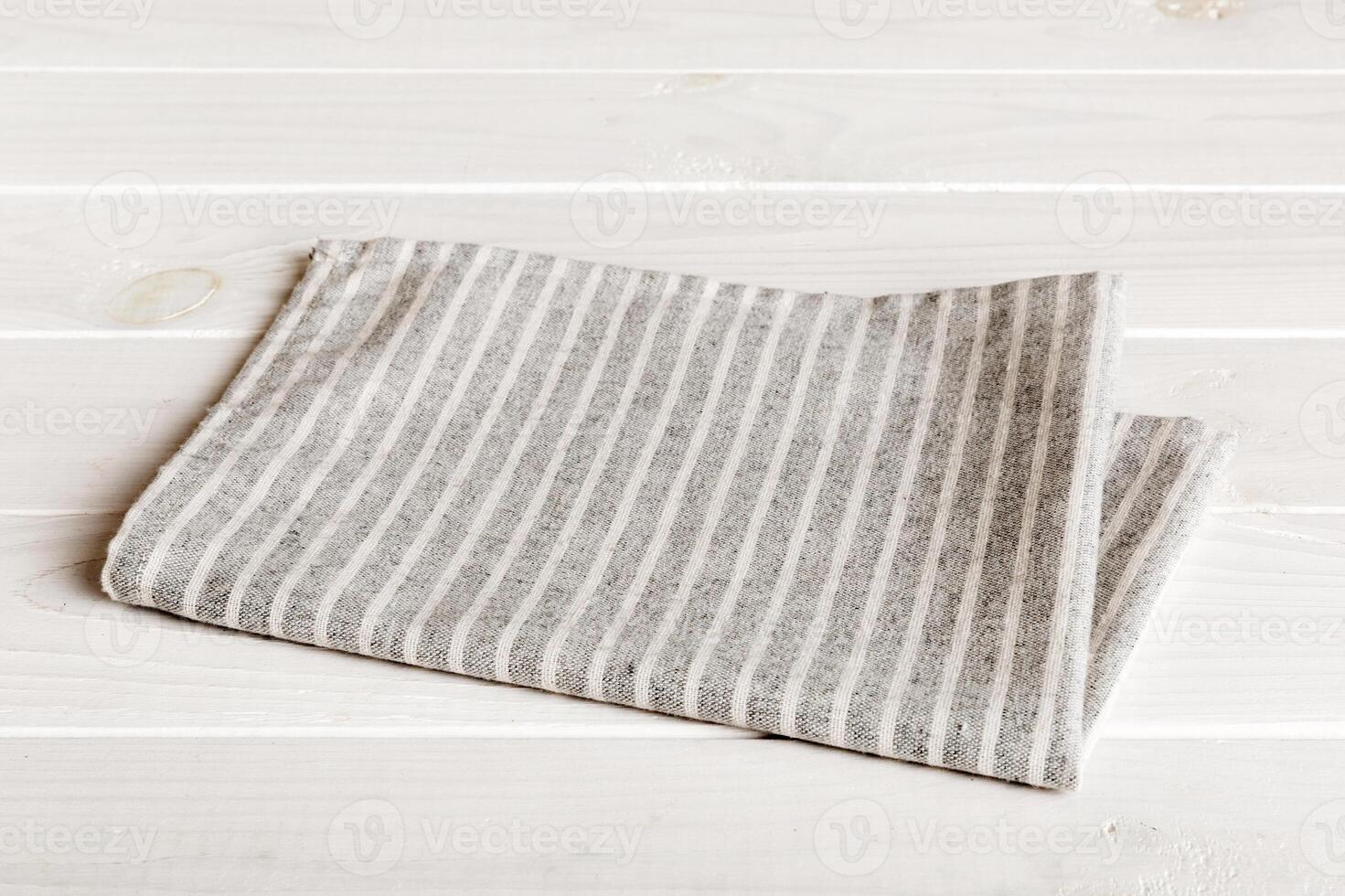 top view gray kitchen napkin isolated on table background. Folded cloth for mockup with copy space photo