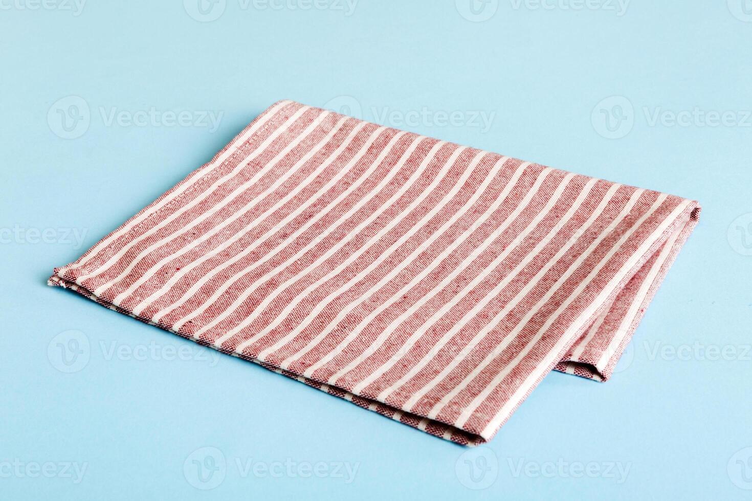 top view with red empty kitchen napkin isolated on table background. Folded cloth for mockup Flat lay. Minimal style photo