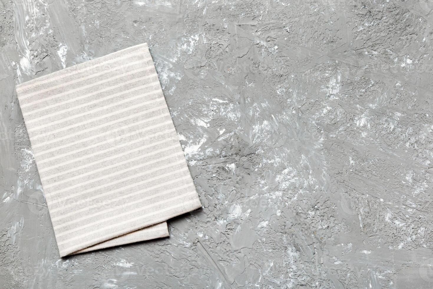 top view with gray kitchen napkin isolated on table background. Folded cloth for mockup copy space photo
