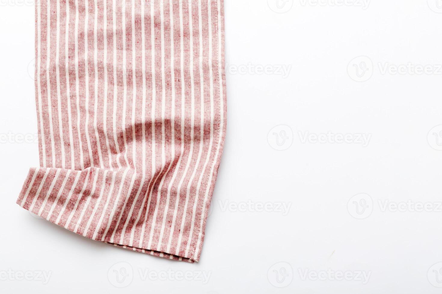 top view red empty kitchen napkin isolated on table background. Folded cloth photo
