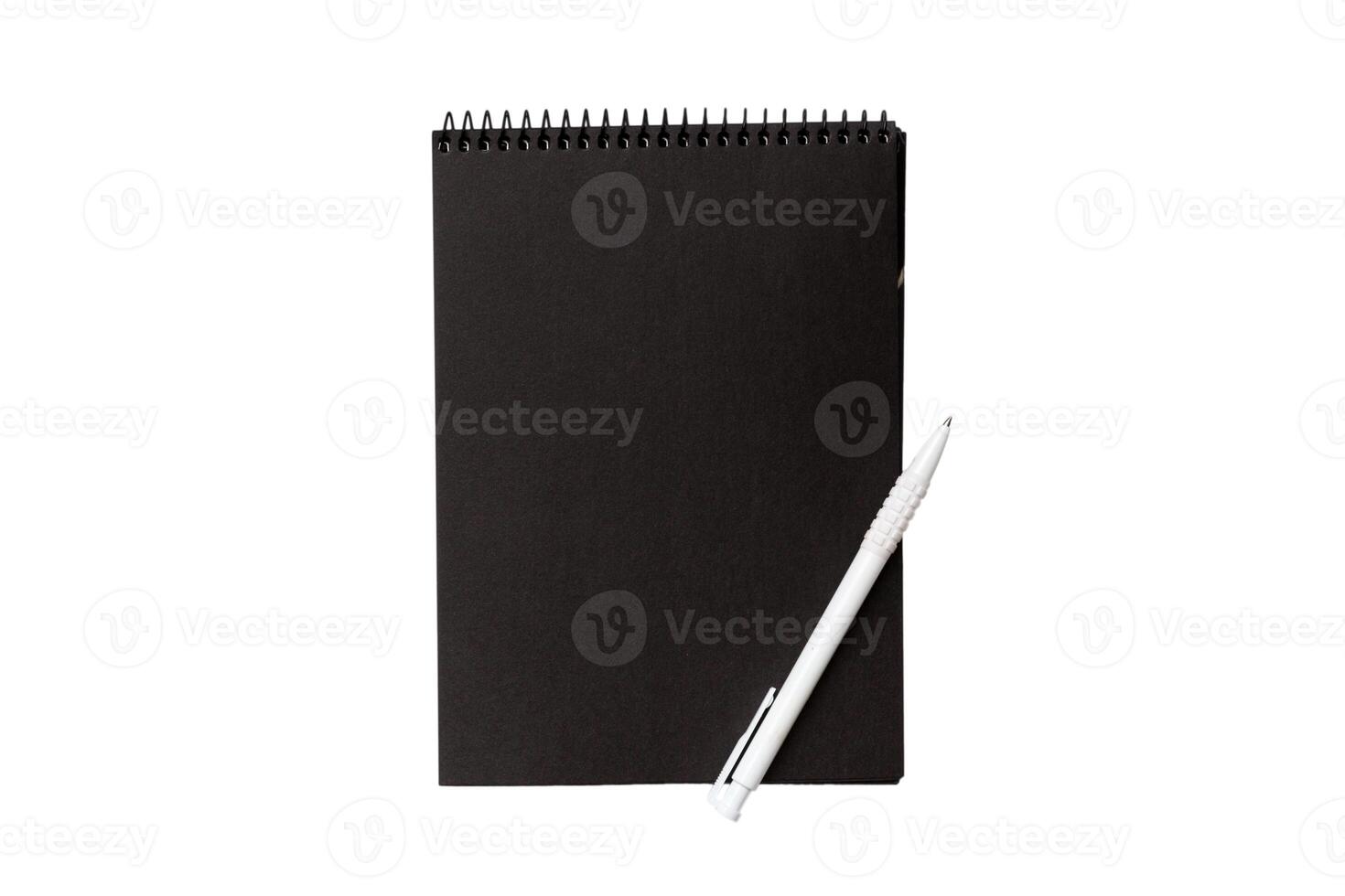 Top view closed spiral blank dark paper cover notebook with pencil isolated on white background photo