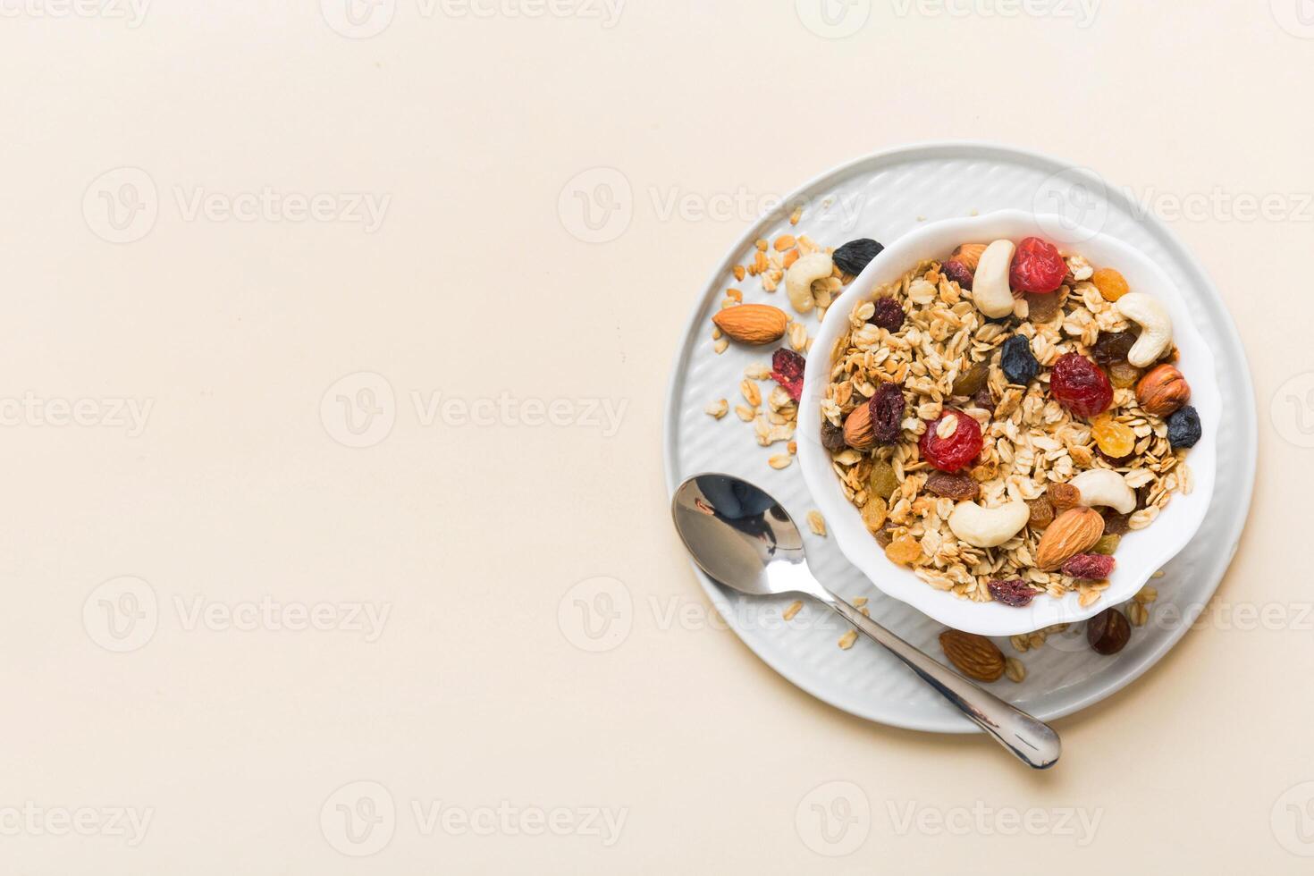 Cooking wholesome breakfast. Granola with Various dried fruits and nuts in a bowl. The concept of a healthy dessert. top view photo