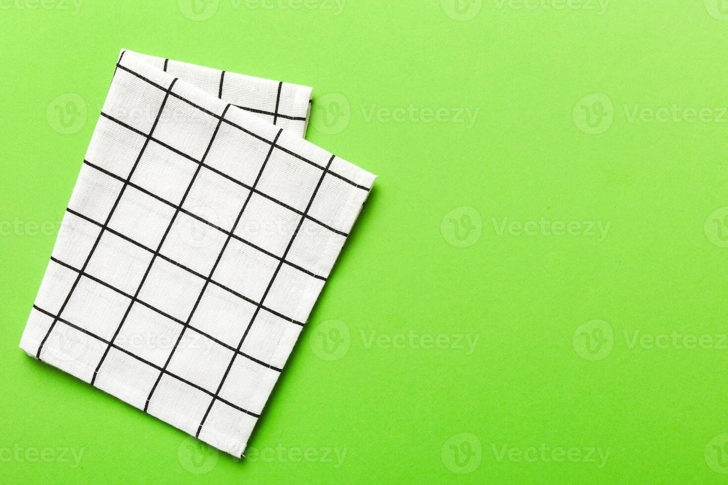 top view with white empty kitchen napkin isolated on table background. Folded cloth for mockup with copy space. Minimal style photo