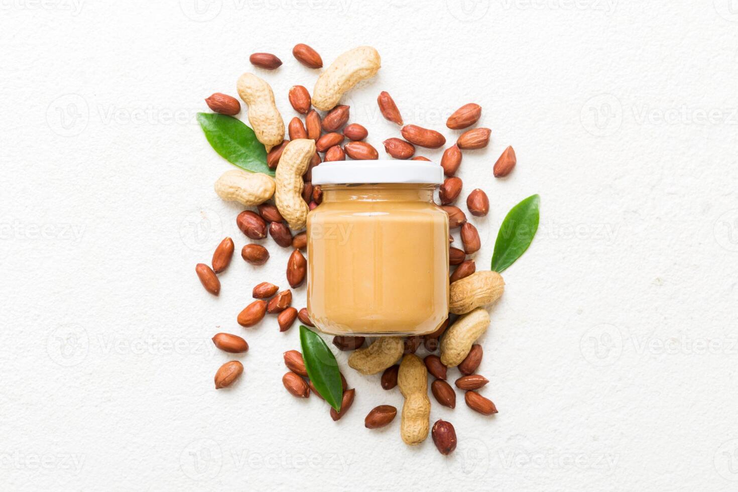 Bowl peanut butter and peanuts table background. top view copy space. Creamy peanut pasta photo