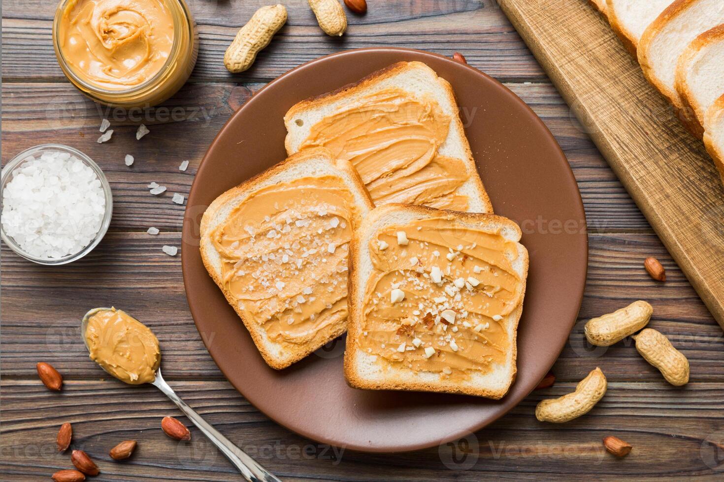Peanut butter sandwiches toasts on light table background. Breakfast. Vegetarian food. American cuisine top view photo