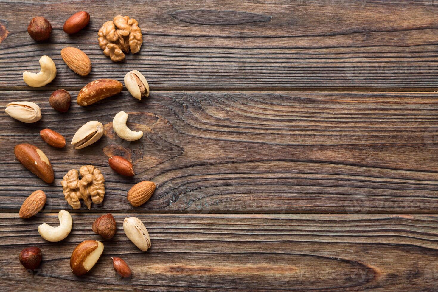 Composition nuts , flat lay - mix hazelnuts, cashews, almonds on table background. healthy eating concepts and food photo