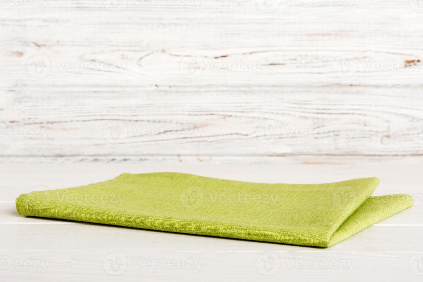 top view with green kitchen napkin isolated on table background. Folded cloth for mockup copy space photo
