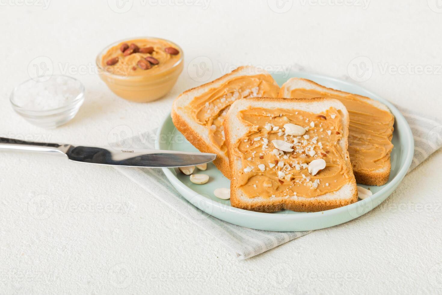 Peanut butter sandwiches or toasts on light table background.Breakfast. Vegetarian food. top view photo